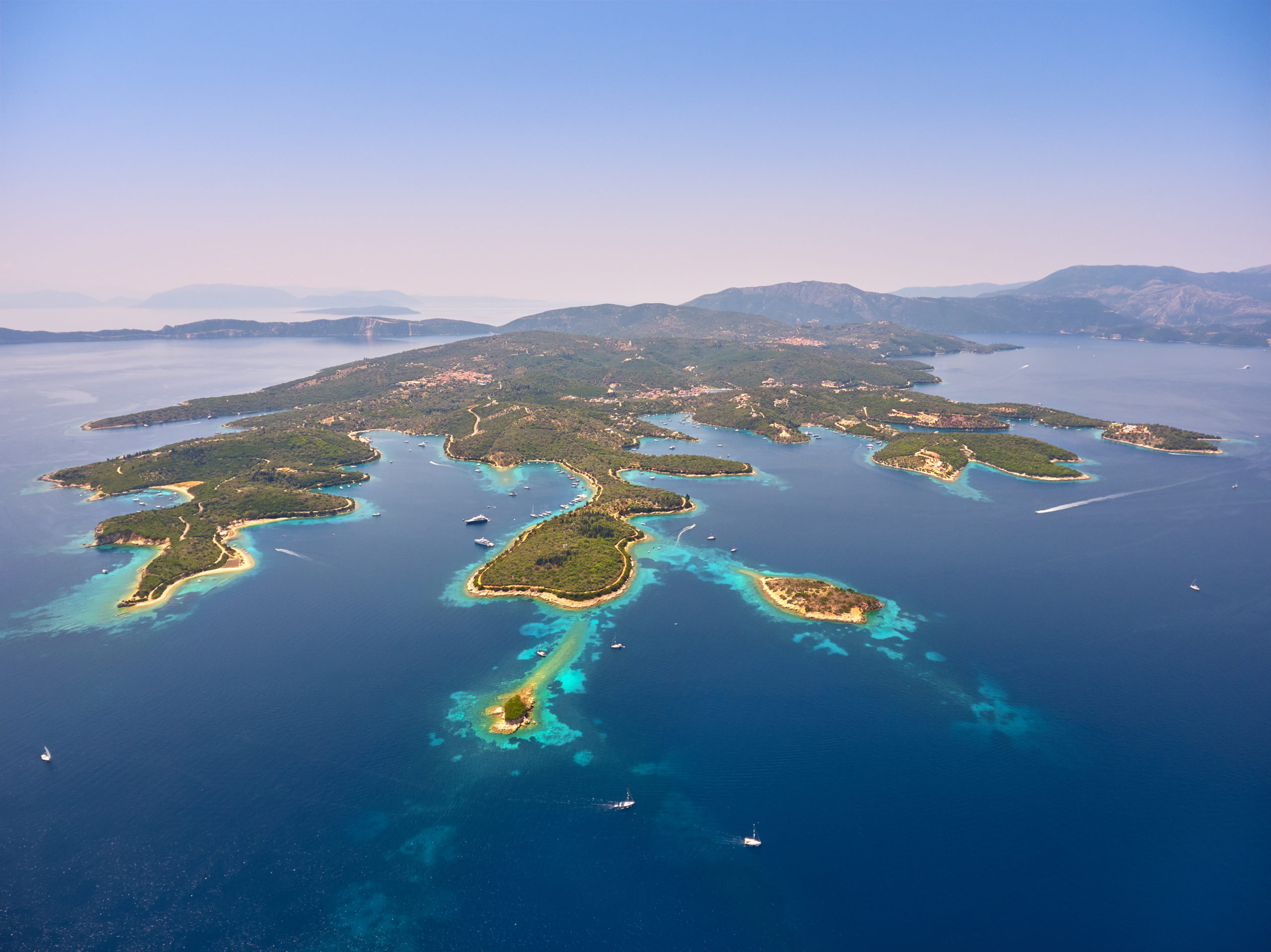 Aerial view of Meganisi Island and nearby islets surrounded by turquoise waters in the Ionian Sea, Greece.