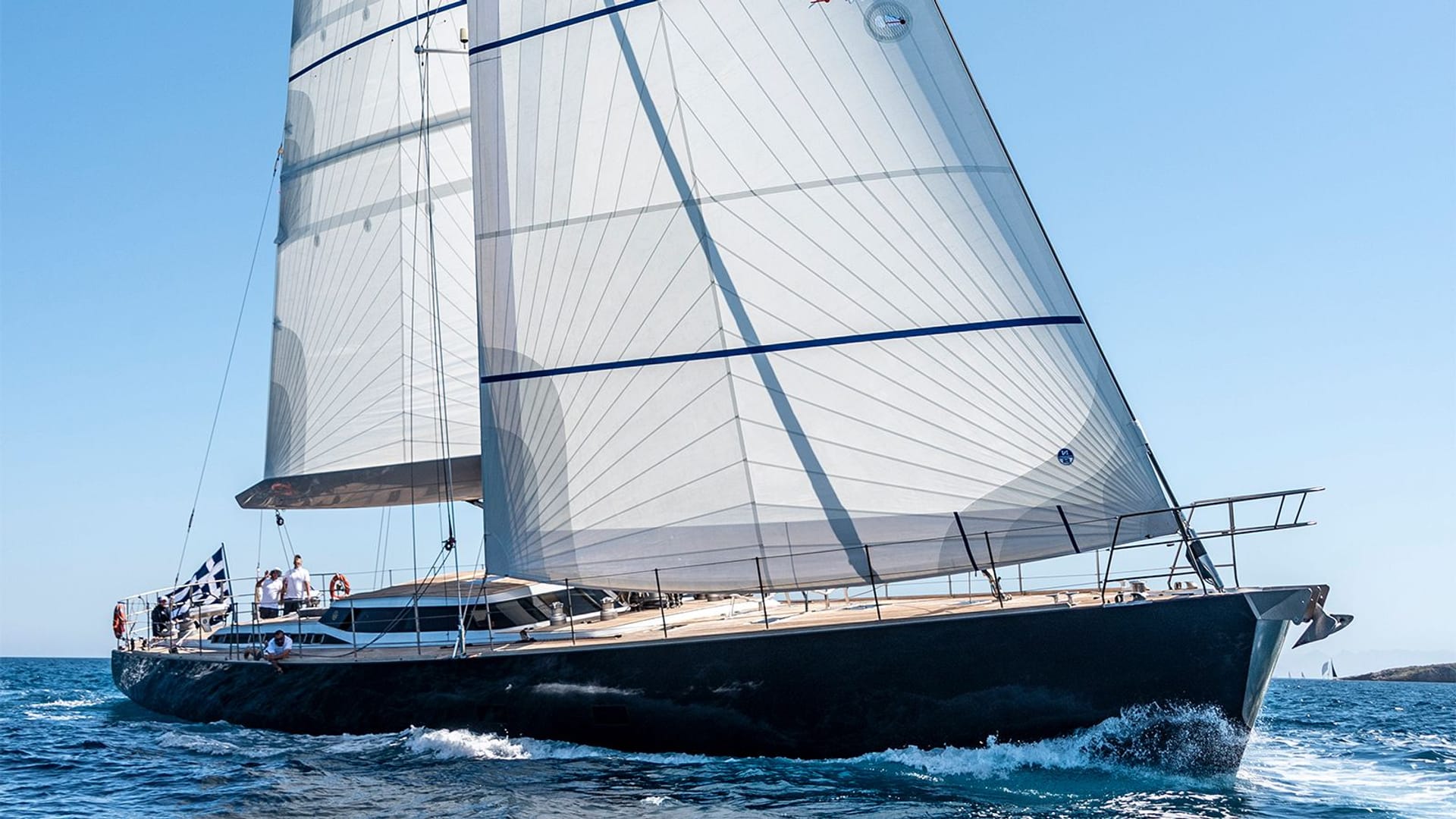 ATALANTE sleek performance sailing yacht gliding through the Aegean Sea under full sail
