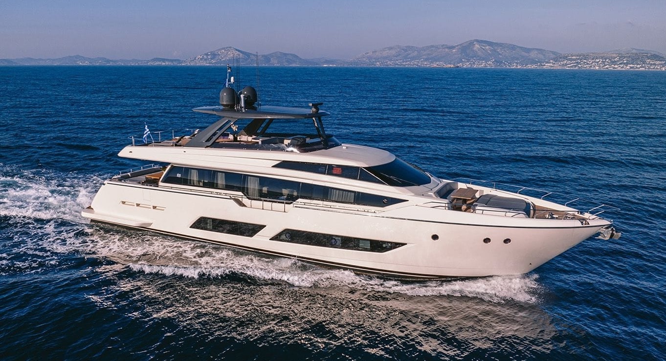 ANASSA A luxury yacht cruising off the Greek coast with mountain views in the background.
