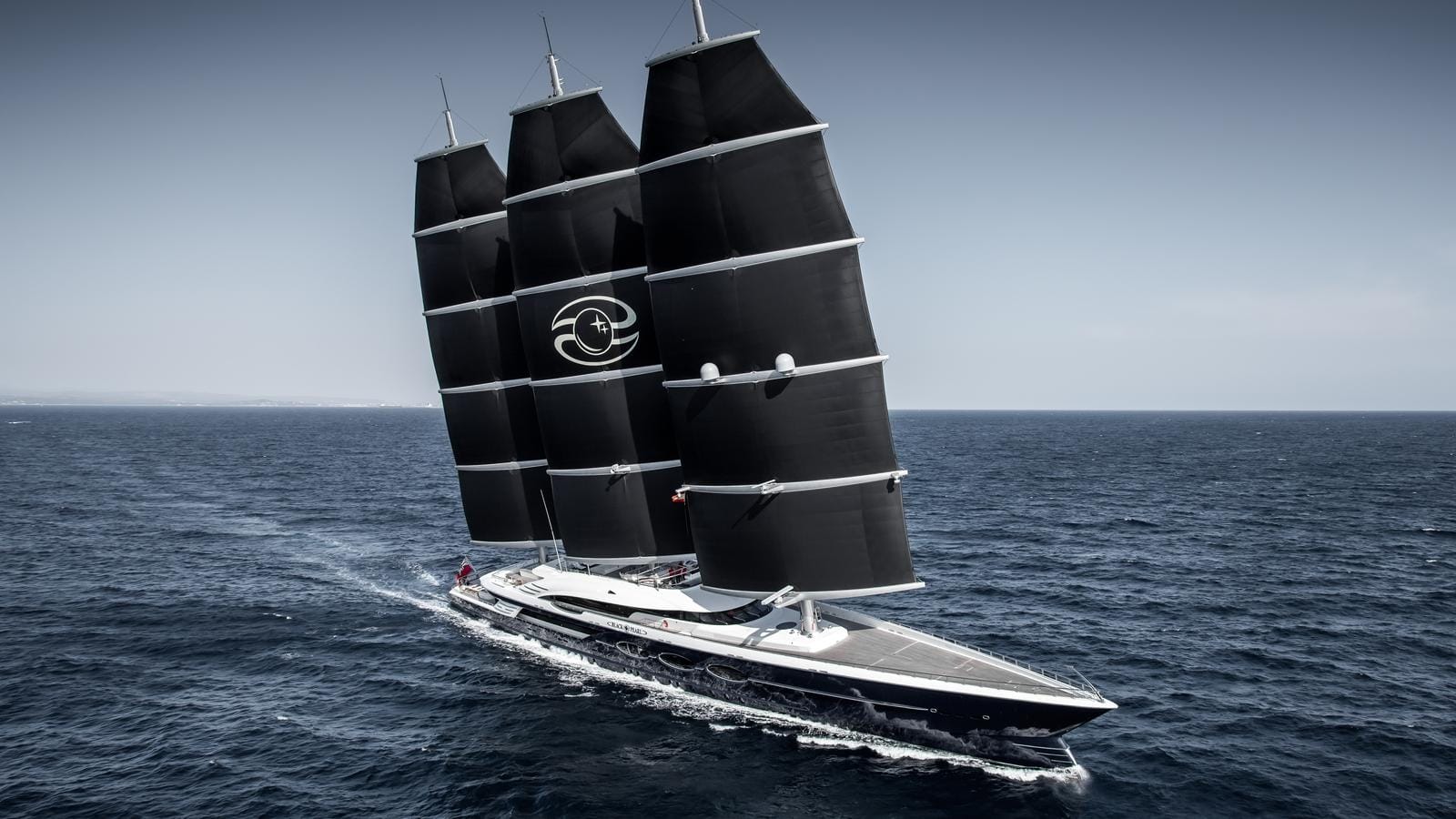 BLACK PEARL sailing yacht with distinctive black DynaRig sails cruising on open water.
